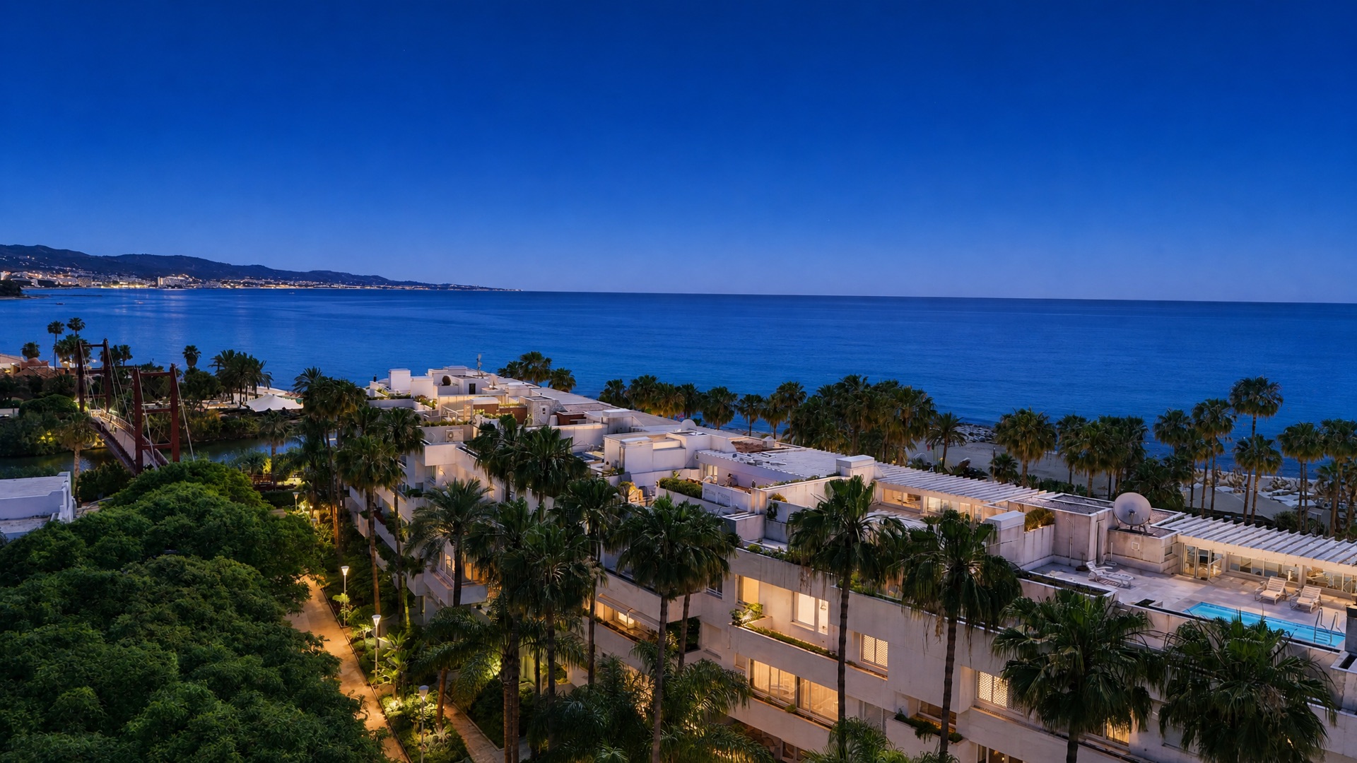 The Puerto Banús coastline at dusk, seen from above La Isla