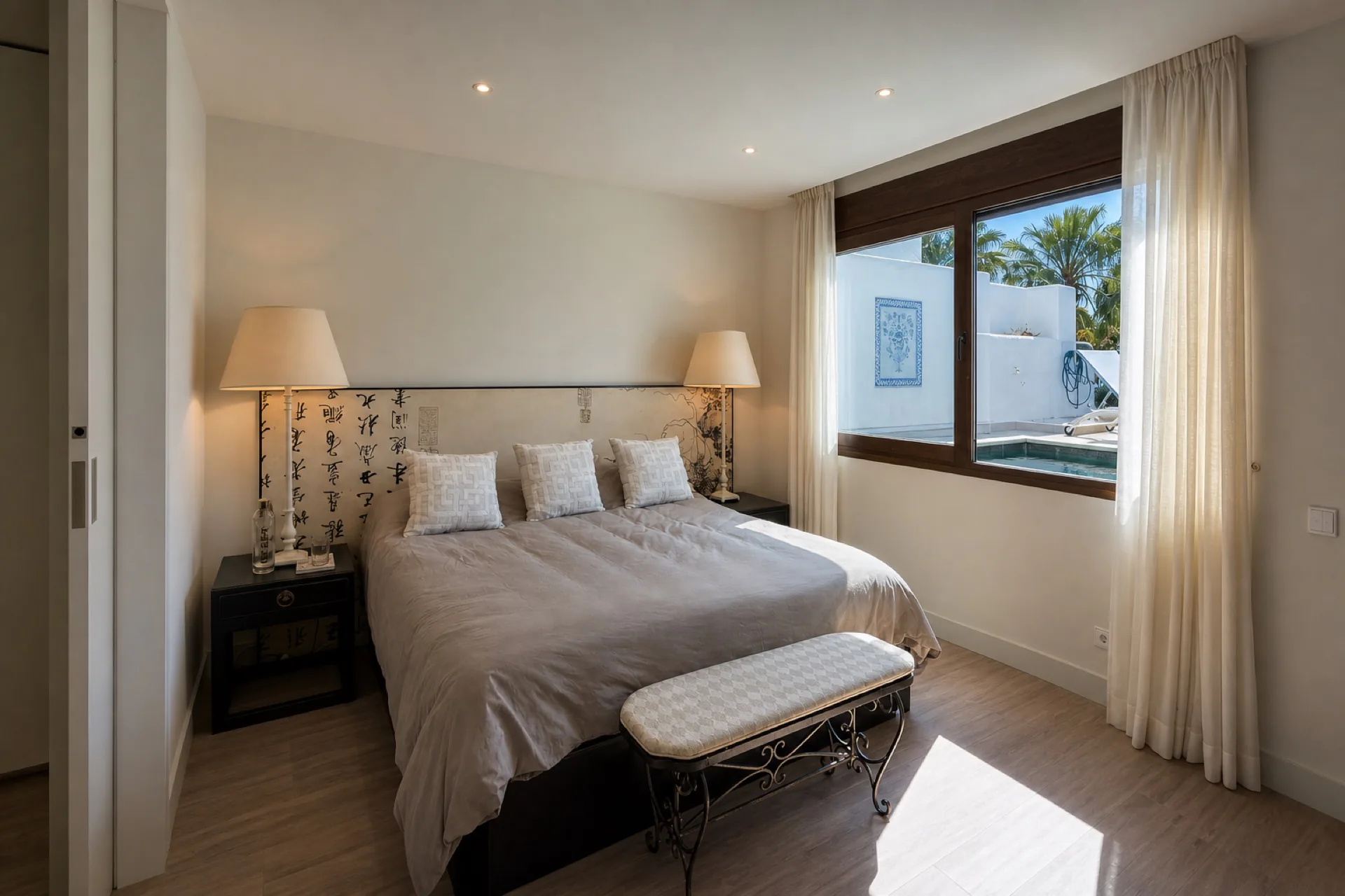 The master bedroom with calligraphy headboard and pool view
