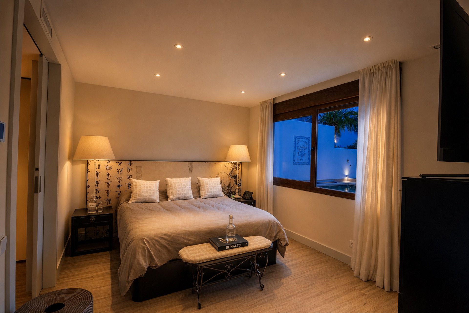 Cozy master bedroom with window view at dusk at the La Isla penthouse