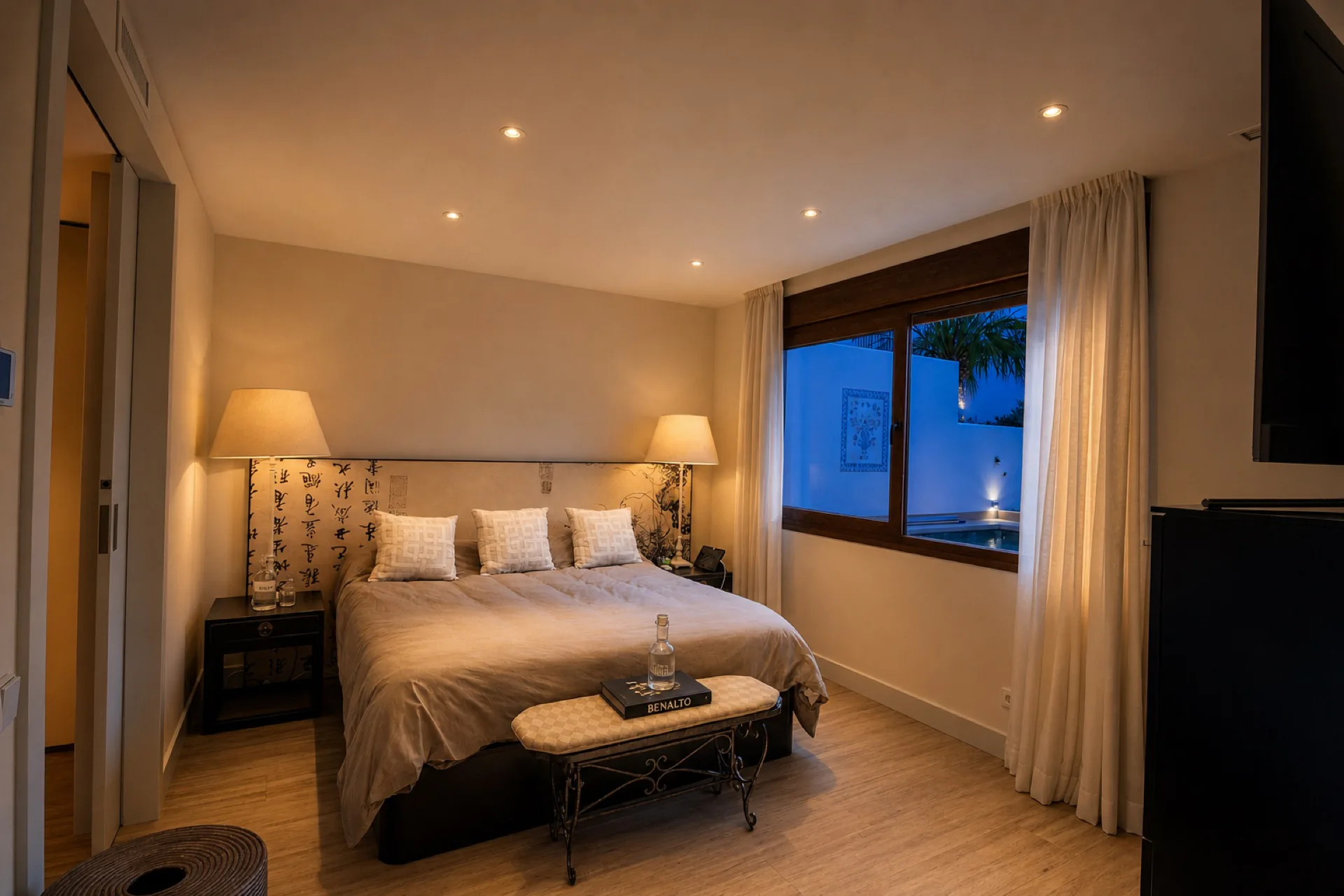 Cozy master bedroom with window view at dusk at the La Isla penthouse