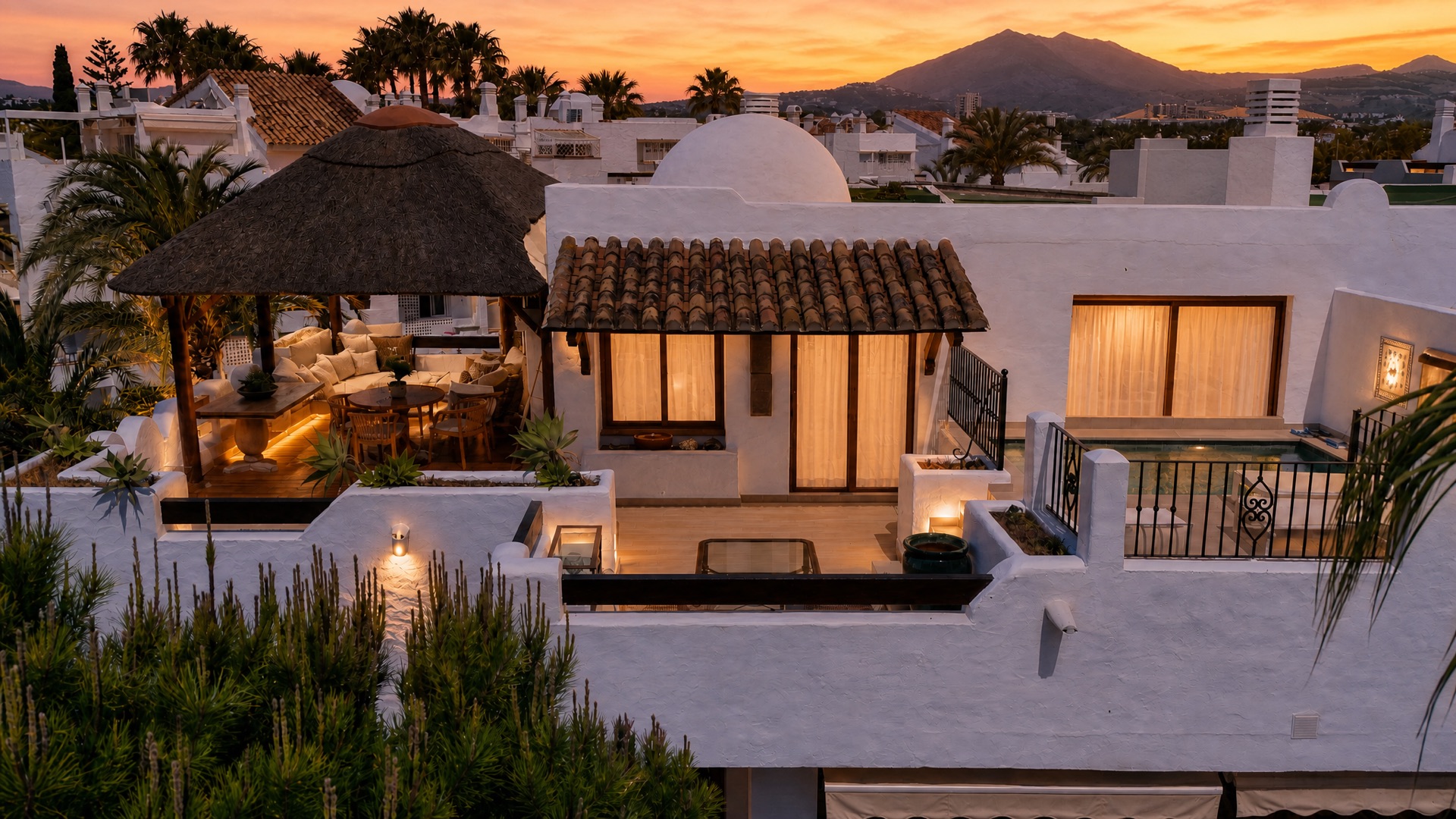 The rooftop gazebo of the La Isla penthouse at dusk, La Concha behind