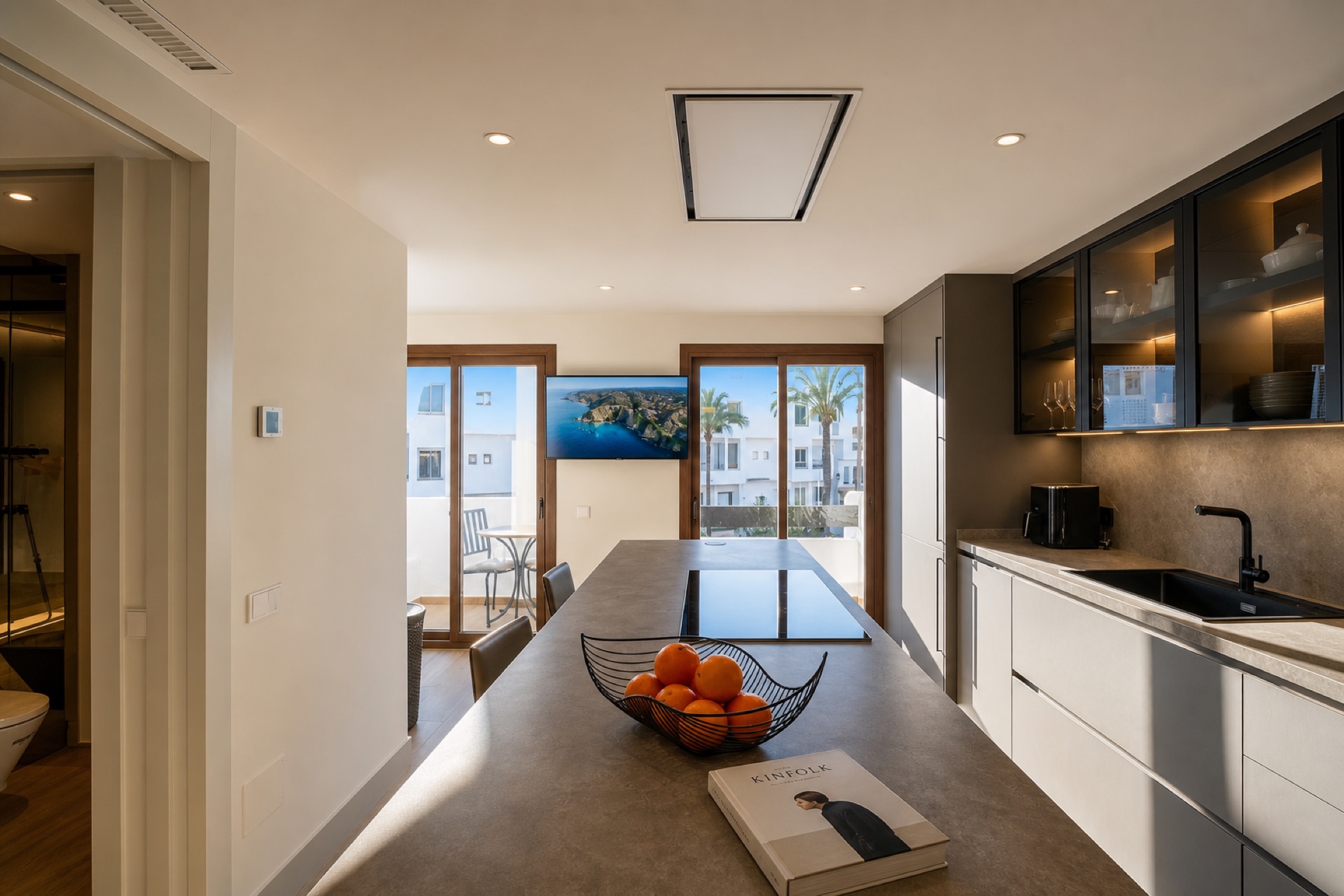 Modern kitchen with island and terrace view at the La Isla penthouse